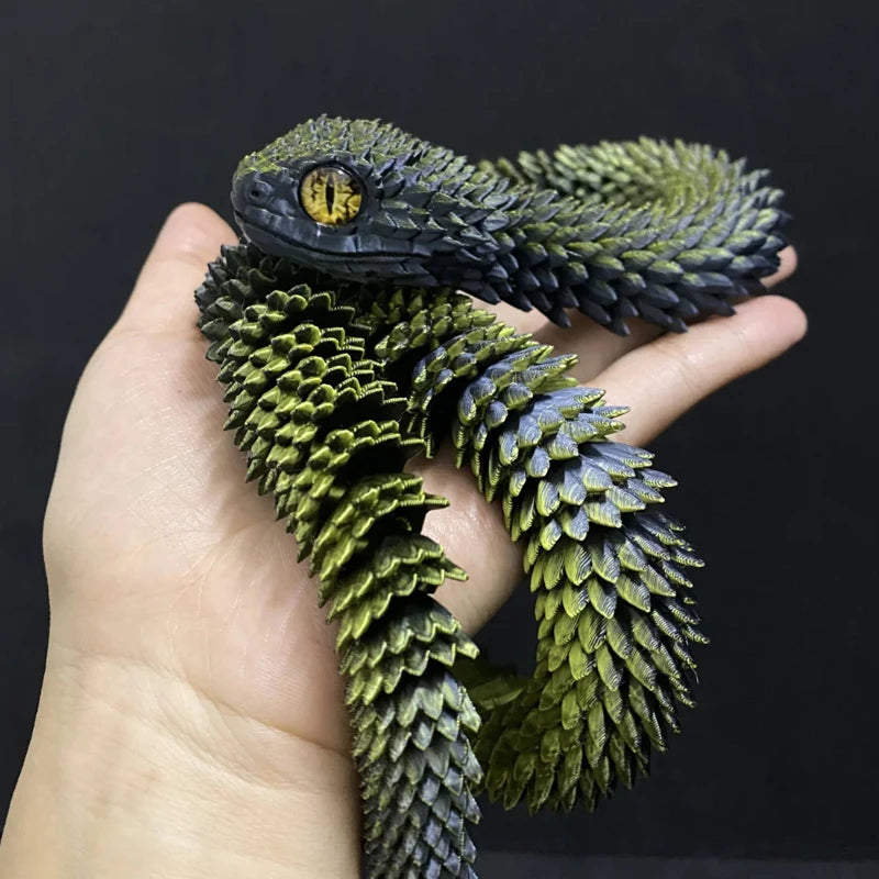 Green and black snake coiled around a person's hand against a dark background