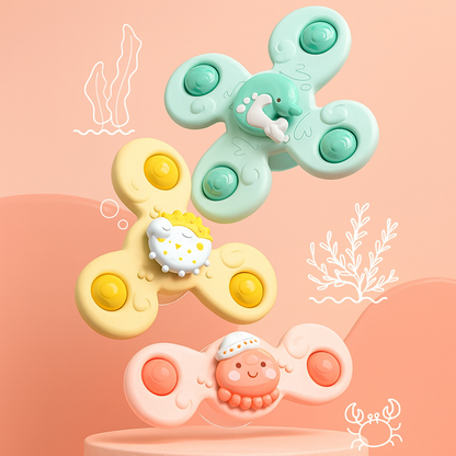 Three colorful fidget spinners with cartoon characters on a pink background
