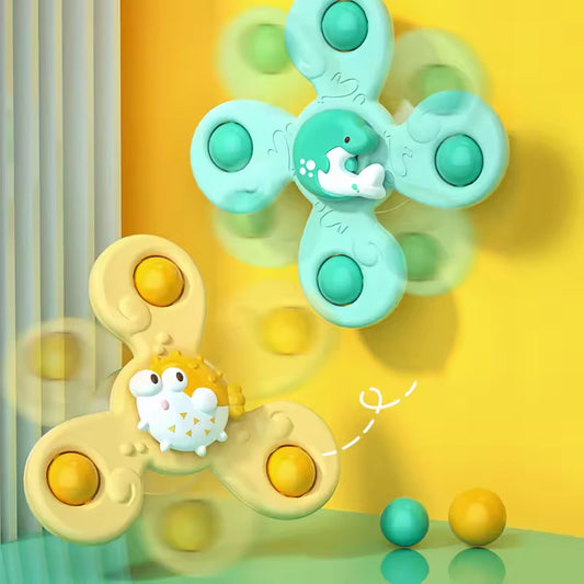 Two fidget spinner toys, one green and one yellow, on a yellow background.