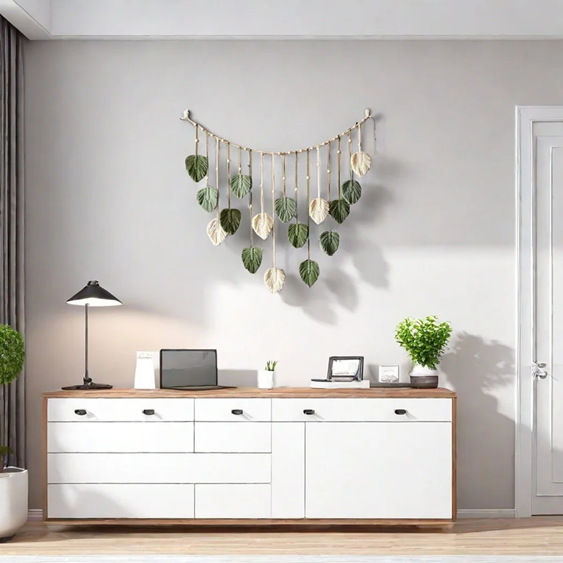 Modern office setup with white desk, computer, lamp, and decorative wall hanging.