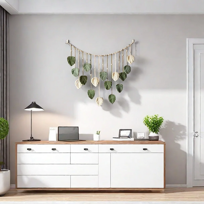 Modern office setup with white desk, computer, lamp, and decorative wall hanging.