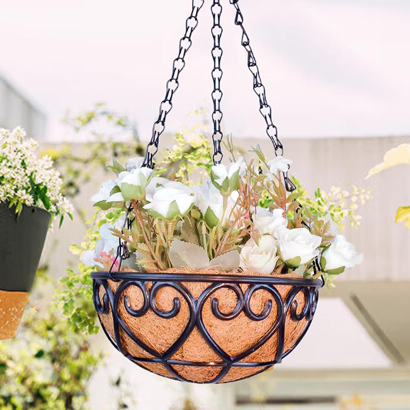 Hanging flower basket with decorative metal frame and plants indoors