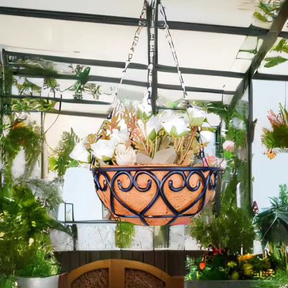 Decorative hanging basket with plants in a greenhouse setting