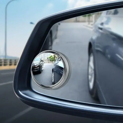 Car side mirror with a convex mirror attachment on a road.