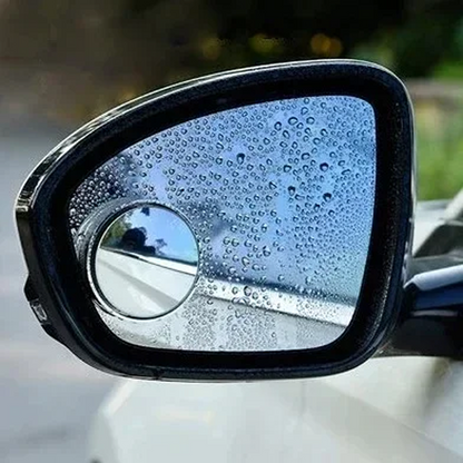 Car side mirror with raindrops on a blurred outdoor background