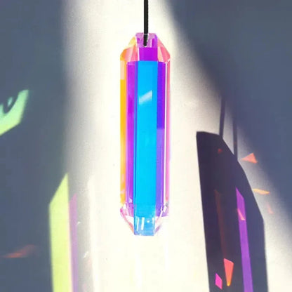 Colorful crystal pendant hanging against a dark background