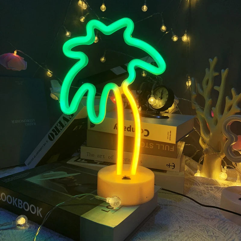 Neon palm tree light on a stack of books with string lights in the background