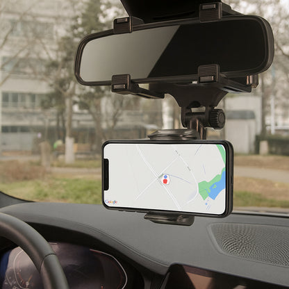 Phone mounted on a car dashboard with a map displayed, showing a rearview mirror above.