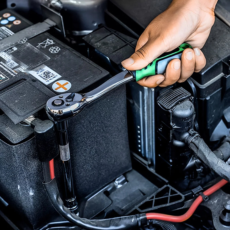 Person using a ratchet wrench on a car battery