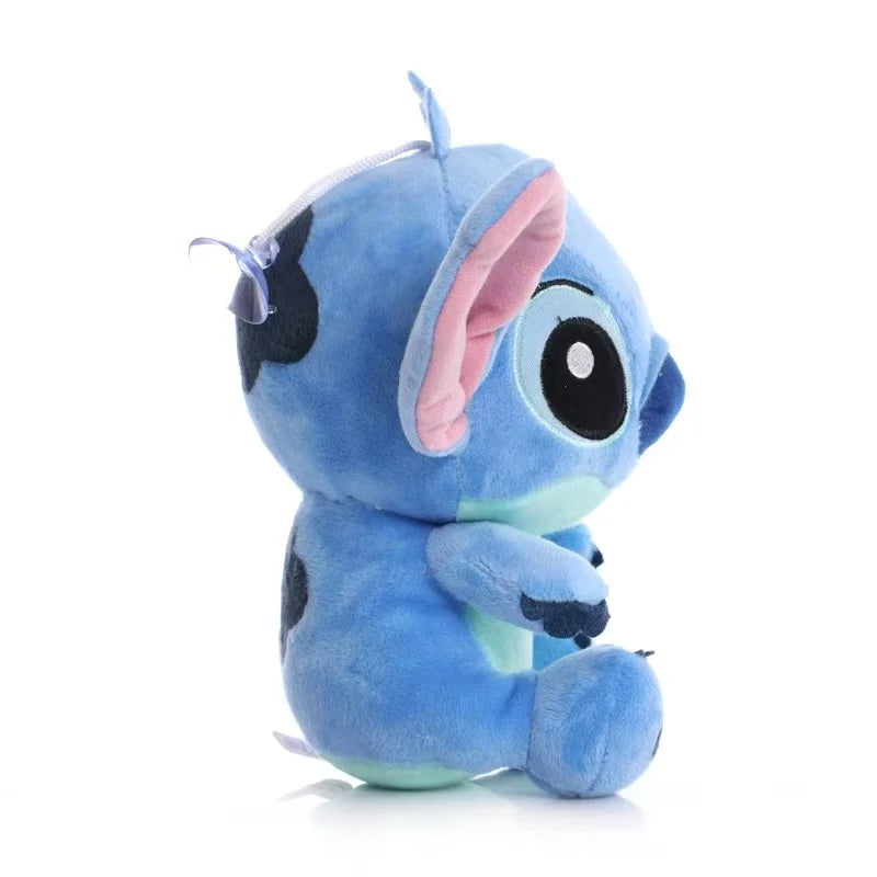Blue plush toy with black spots and pink inner ear on a white background
