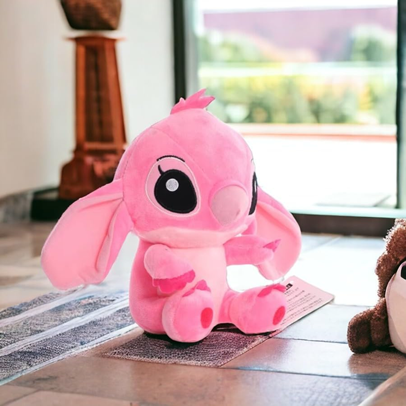Pink plush toy on a wooden floor with a blurred background