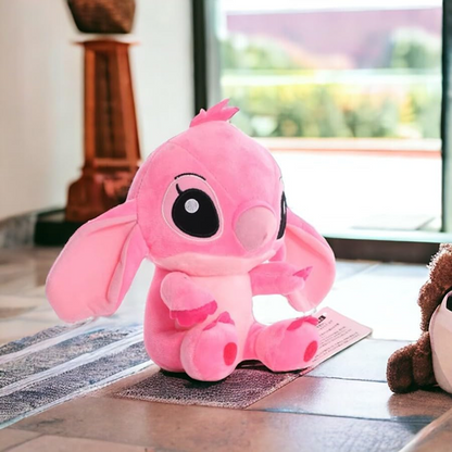 Pink plush toy on a wooden floor with a blurred background