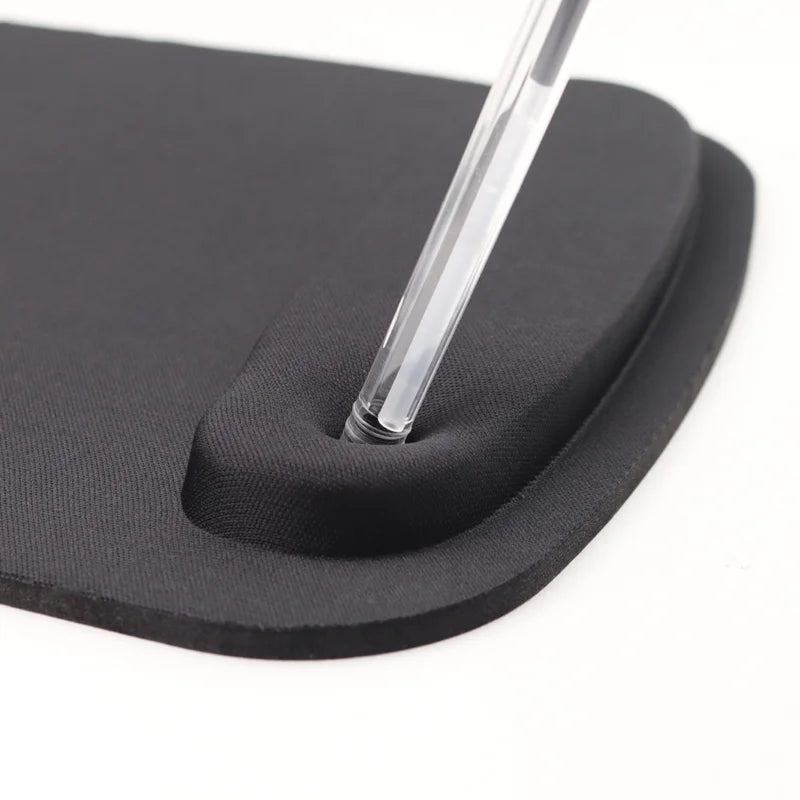 Black rubber mouse pad with a clear plastic tool on a white background
