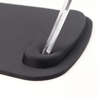 Black rubber mouse pad with a clear plastic tool on a white background