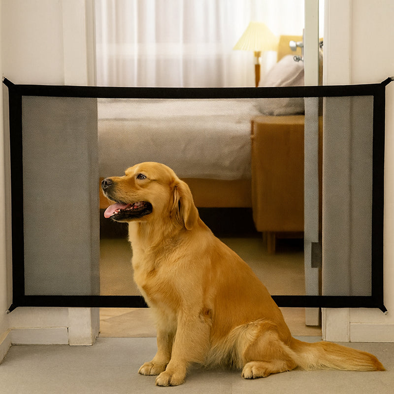 Dog sitting behind a foldable pet safety gate in a home setting