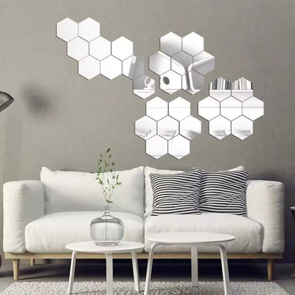 Hexagonal mirror wall decors on a gray wall above a white sofa.