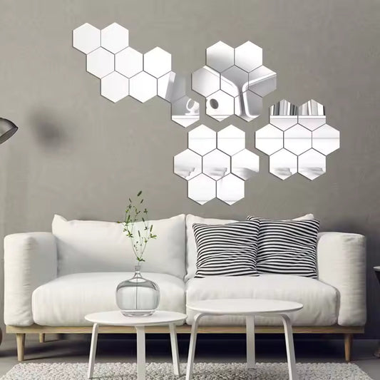 Hexagonal mirror wall decors on a gray wall above a white sofa.