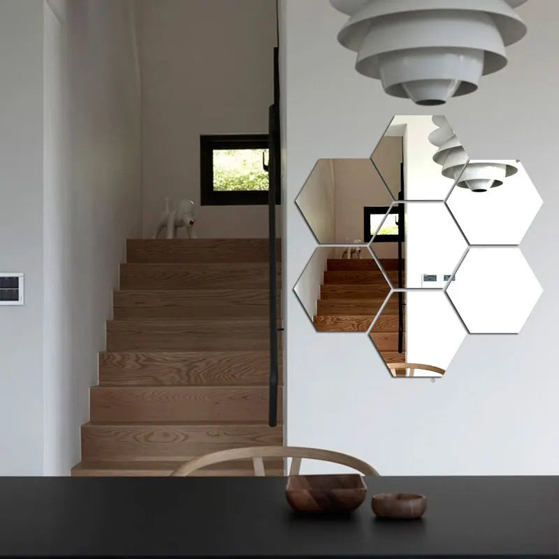 Modern interior with wooden staircase and hexagonal mirrors on the wall.