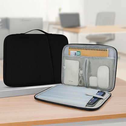 Black and gray laptop bag on a wooden surface with office items inside, blurred office background.