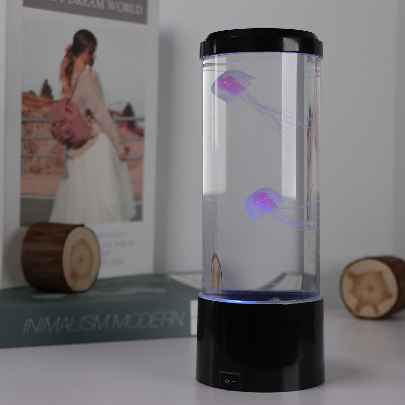 Decorative lamp with jellyfish-like lights on a table next to a book titled 'Minimalism Modern'.