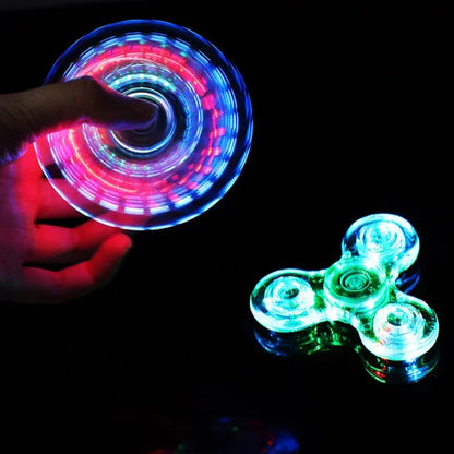 Hand holding a glowing LED spinner with another spinner on a black background