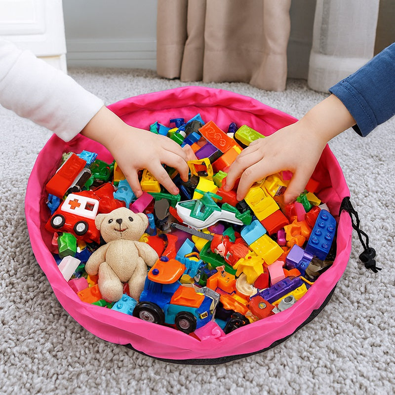 Children playing with colorful building blocks in a pink storage bin on a carpeted floor.