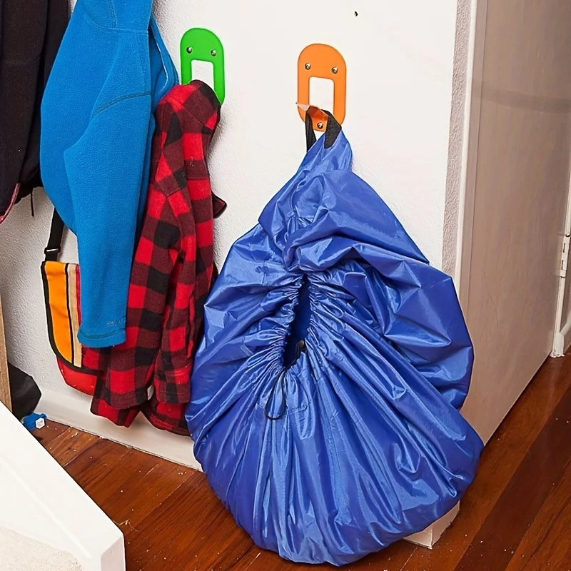 Blue drawstring bag on the floor next to colorful hangers with clothes