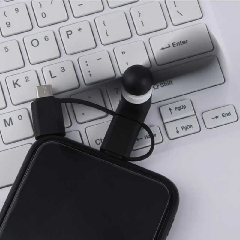 Black phone case with a USB cable on a white keyboard