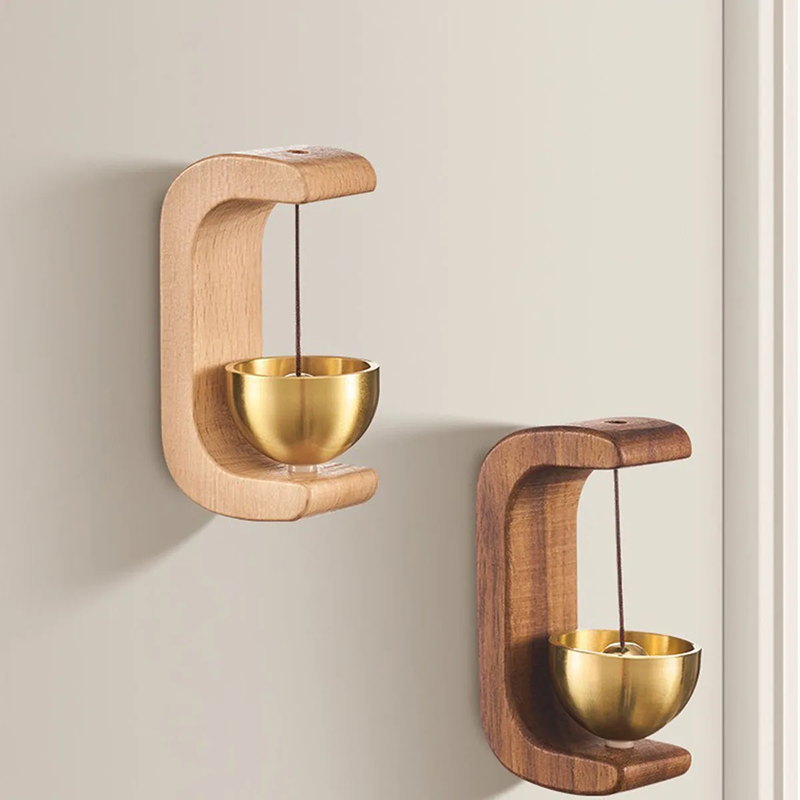 Wooden and gold balance toy on a wall