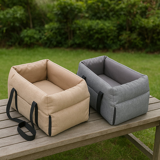Two pet carriers, one beige and one gray, on a wooden table outdoors.
