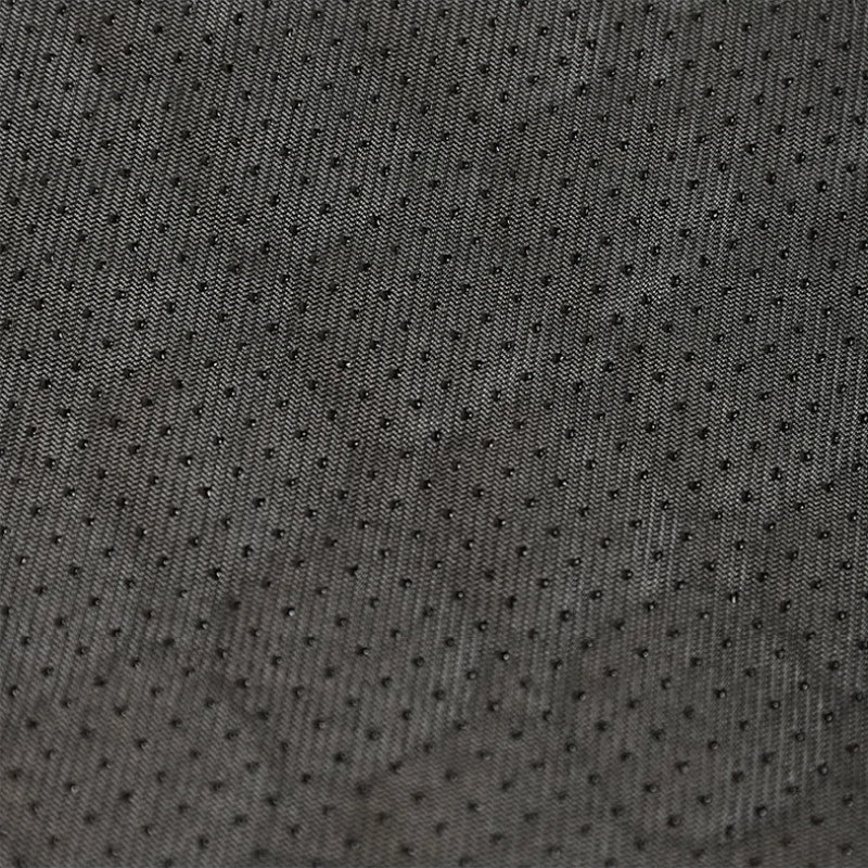 Close-up of dark gray textured fabric with small holes