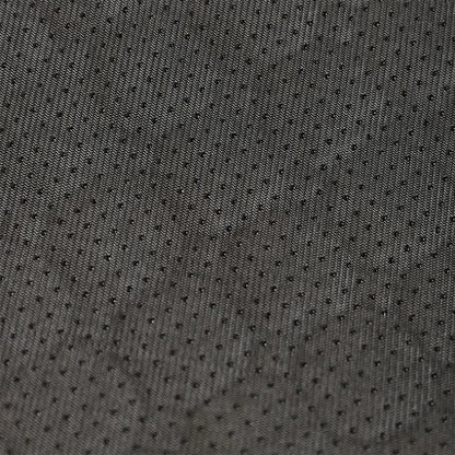 Close-up of dark gray textured fabric with small holes