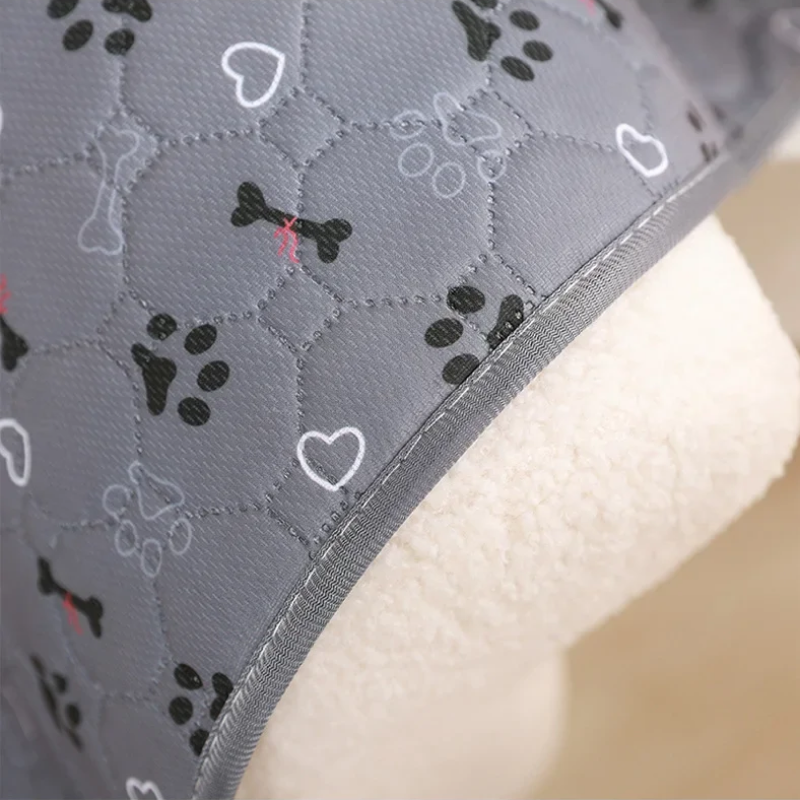 Gray quilted fabric with dog-themed patterns on a beige background