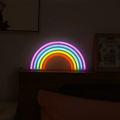 Colorful rainbow-shaped light on a shelf in a dimly lit room