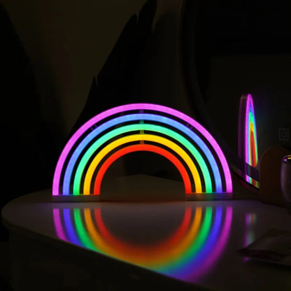 Neon rainbow light on a reflective surface with a dark background
