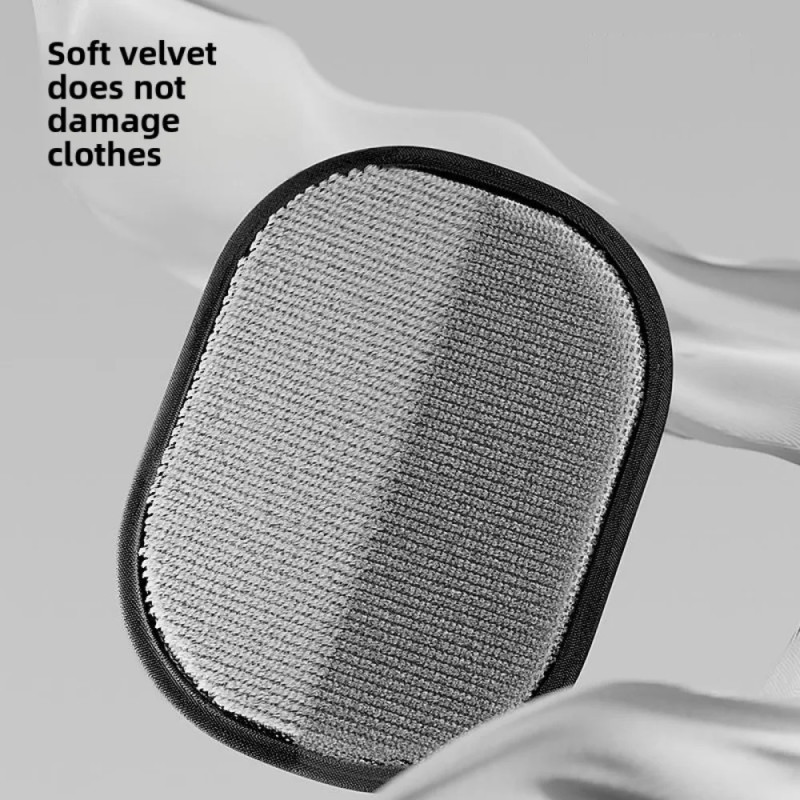 Gray cleaning pad with black border on a white fabric background