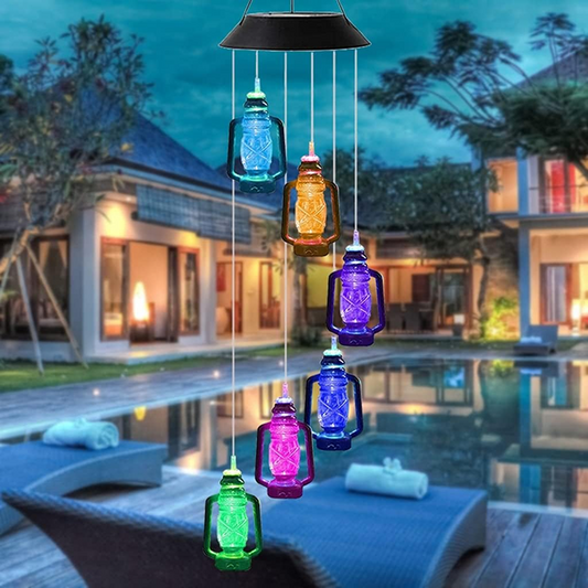 Colorful solar-powered hanging lights in front of a pool and house.