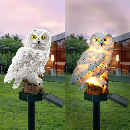 Solar-powered owl light on a grassy area with a house in the background