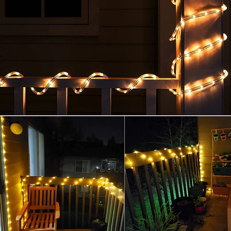 String lights on a railing and around a bench on a deck at night.