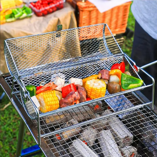 Portable grill with vegetables on a grassy outdoor setting