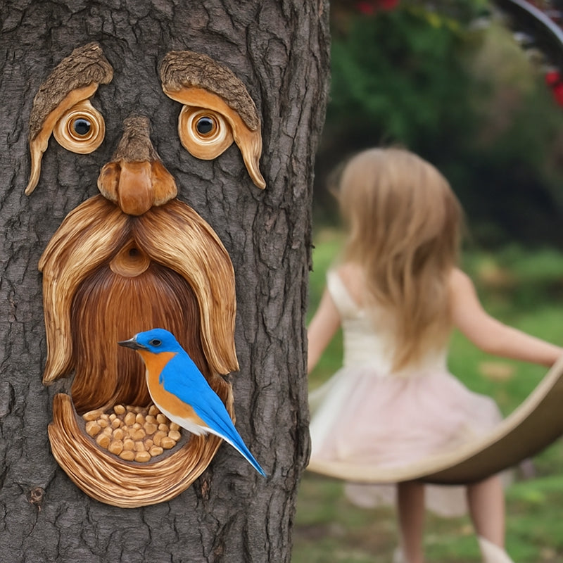 Wooden bird feeder shaped like a face on a tree trunk with a blue bird perched on it, and a blurred background of a child playing.