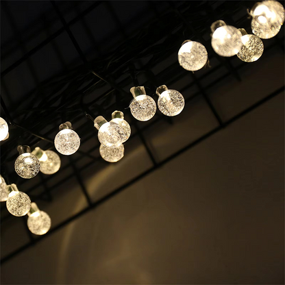 String of decorative lights hanging against a dark background