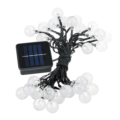String of white lights with solar panel on a white background